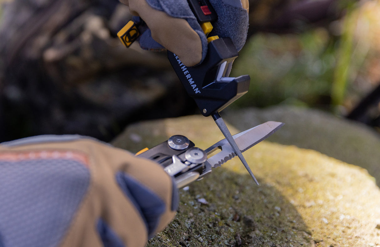 Translation missing: en.Man using Leatherman blade sharpener to sharpen Leatherman Signal