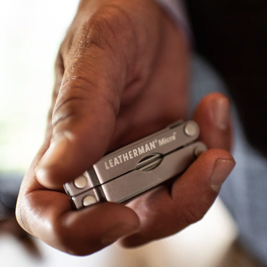 Translation missing: en.Hand holding a compact Leatherman Micra keychain multi-tool