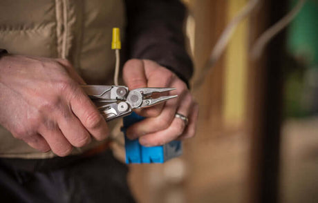 Translation missing: en.Person using a Stainless Steel Leatherman Wave® Plus for skilled trades jobs