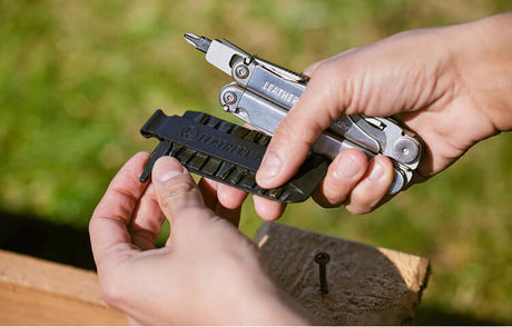 Translation missing: en.User holding a Stainless Steel Leatherman Wave® Plus multi-tool with a bit kit