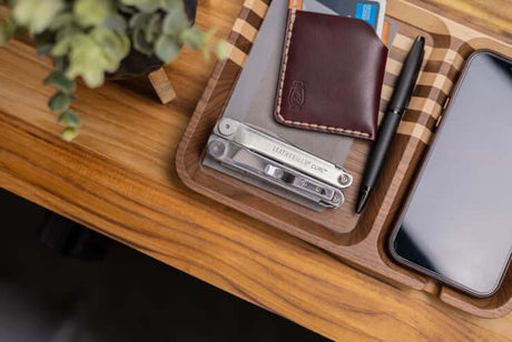 Translation missing: en.Stainless Steel Leatherman Curl® on a wooden tray with a wallet, pen and phone