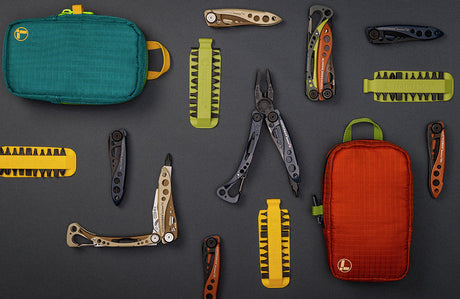 Translation missing: en.Collection of new Leatherman products including multi-tools, folding knives, bit kits, and colorful carrying pouches arranged on a dark background