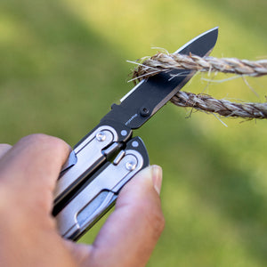 Translation missing: en.Person using one hand to open a Black DLC and stainless steel Leatherman ARC® multitool