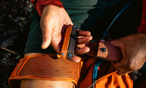 Translation missing: en.Person holding a closed Burnt Sienna bond in one hand and an open Sienna sheath in the other hand