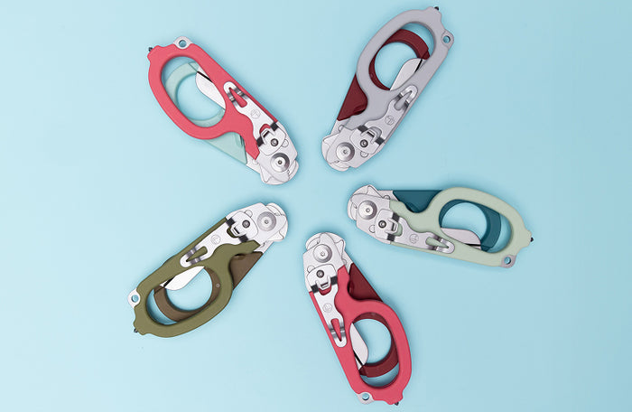 Translation missing: en.Four Leatherman Raptor Rescue shears in different color combinations arranged in a circular pattern on a light blue background, showcasing the Colors Collection