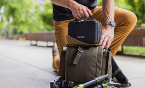 Translation missing: en.Man placing Leatherman® Adapt Kit in crossbody bag