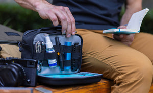 Translation missing: en.Man pulling pen from Leatherman® Adapt Kit to write on notepad