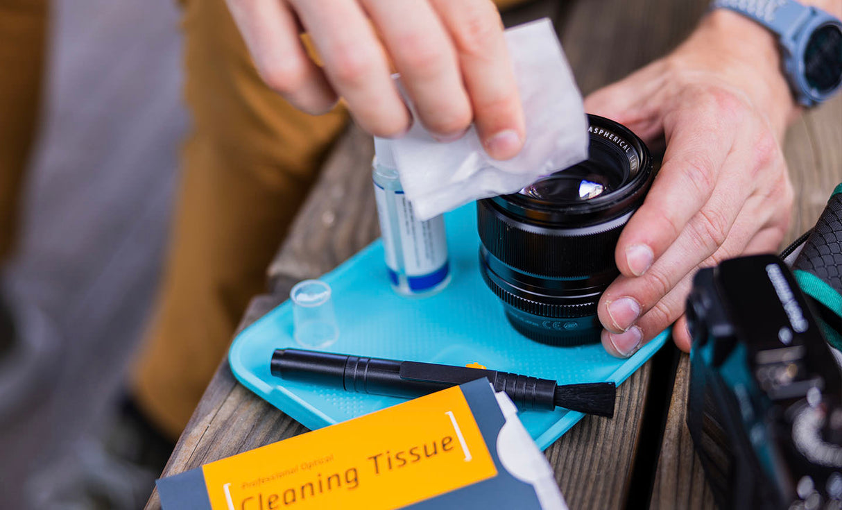 Translation missing: en.Man using Leatherman® Adapt Kit tray to clean camera lens