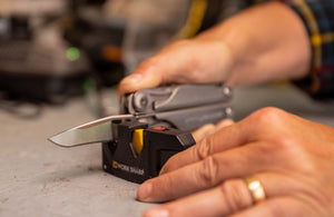 Translation missing: en.Man sharpening Leatherman Surge with Leatherman Blade Sharpener
