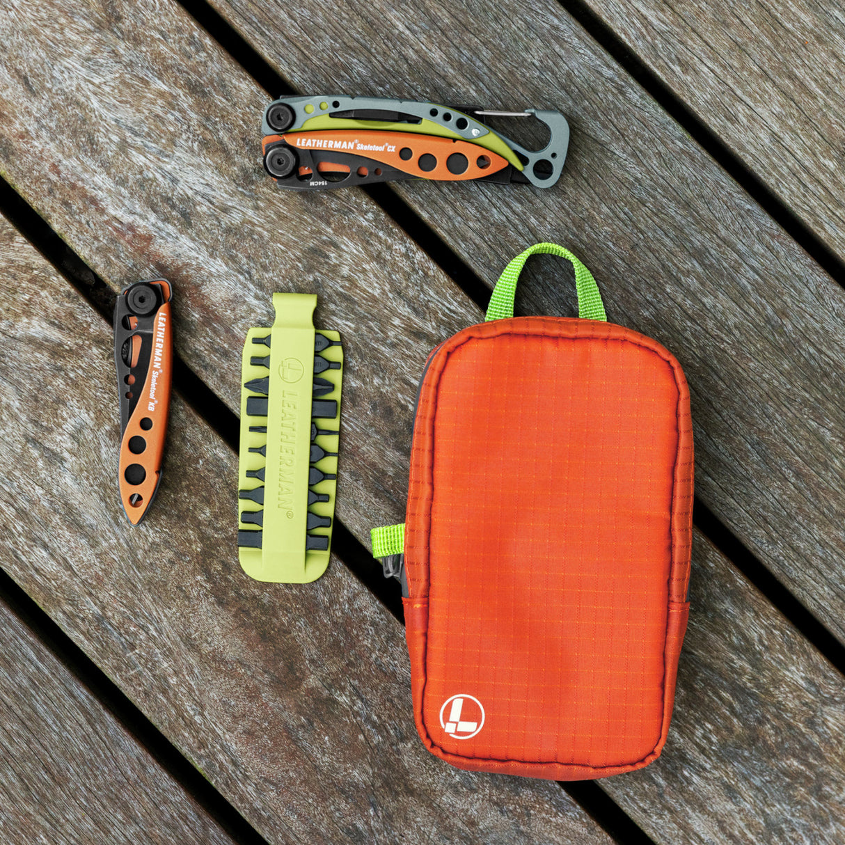 Translation missing: en.Aurora Leatherman tool pouch with bright zipper pull beside multitools and bit kit on wooden surface