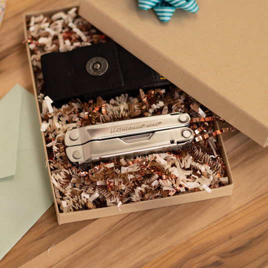 Translation missing: en.Leatherman Bond multi-tool presented in an open gift box with nylon sheath and decorative filler