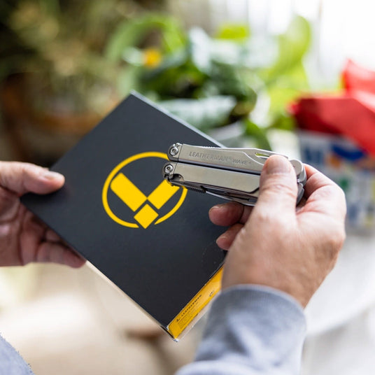 Translation missing: en.Hands holding a boxed Leatherman Wave+ multi-tool gift set