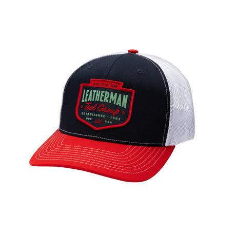 Translation missing: en.Navy Pacific Northwest Trucker Hat with a red brim and a stitched emblem. Established 1983