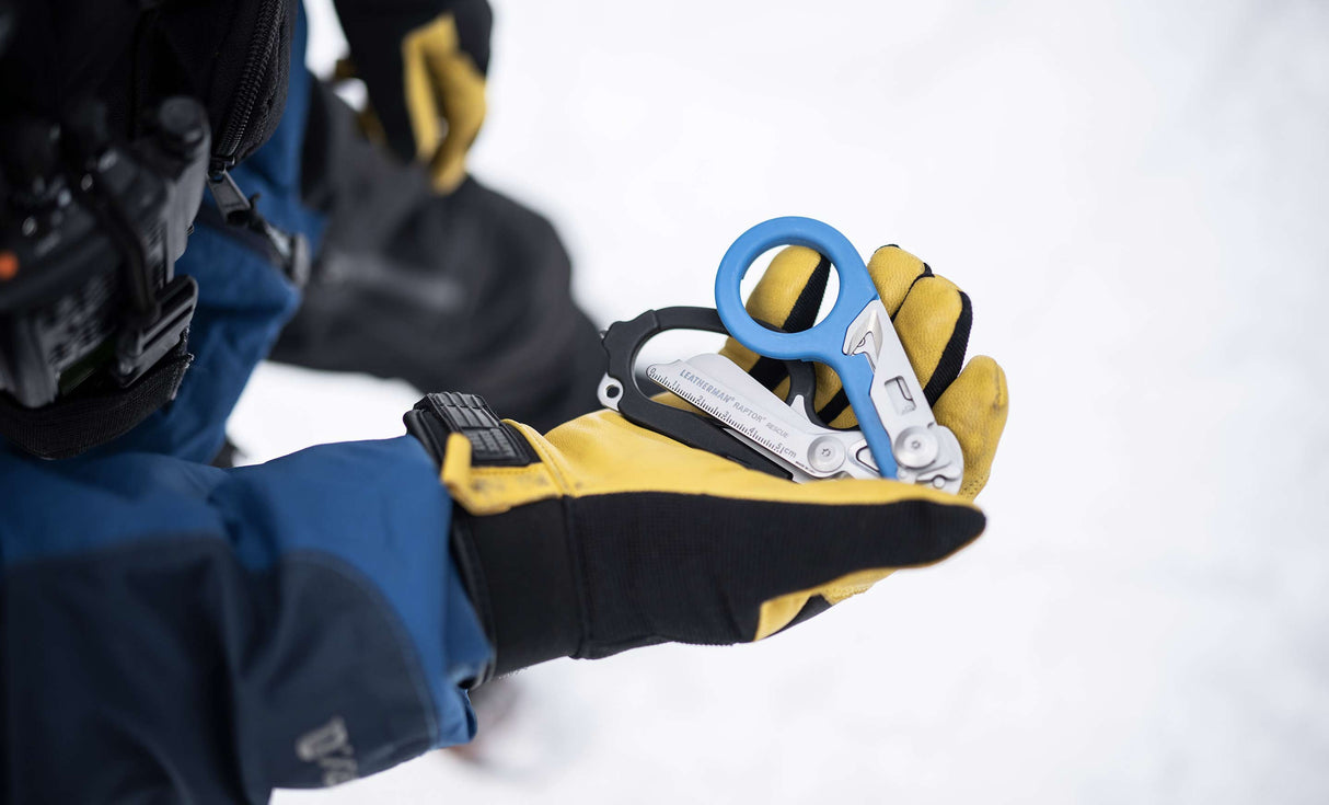 Translation missing: en.Blue and black Leatherman Raptor® Rescue shears partially open in a persons gloved hand