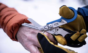 Translation missing: en.Blue and Black Leatherman Raptor® Rescue ring cutter being used to cut a ring off a finger