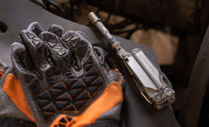 Translation missing: en.Ratchet driver in Leatherman Wave+ bit holder next to set of gloves
