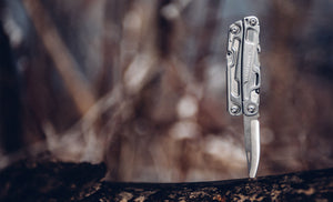 Translation missing: en.Leatherman Rev knife stuck in a log