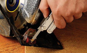 Translation missing: en.Man using Leatherman Super Tool 300 to tighten screw on saw machine
