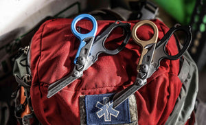 Translation missing: en.Blue black and Coyote Tan Leatherman Raptor® Rescue shears laying on an emergency responders bag