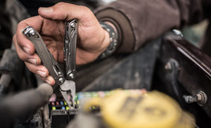 Translation missing: en.Hand using a stainless steel Leatherman Wingman® pliers to remove a fuse from a vehicle's electrical system
